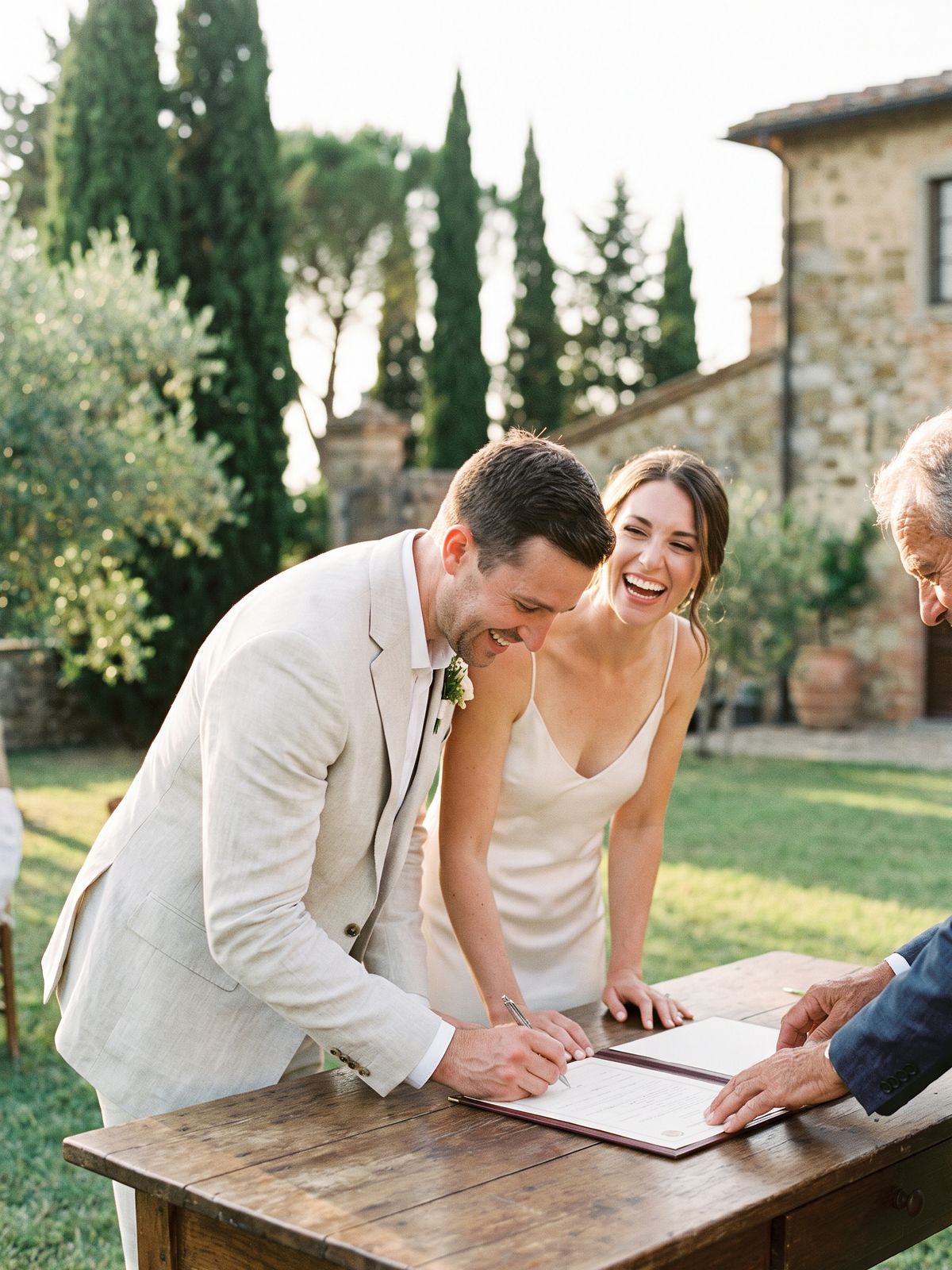 Couple signing their marriage register at an outdoor ceremony in Tuscany